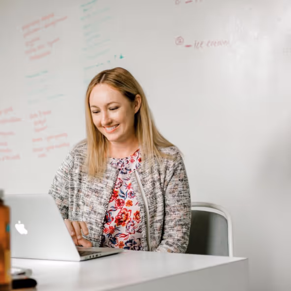 A woman looking at a laptop
