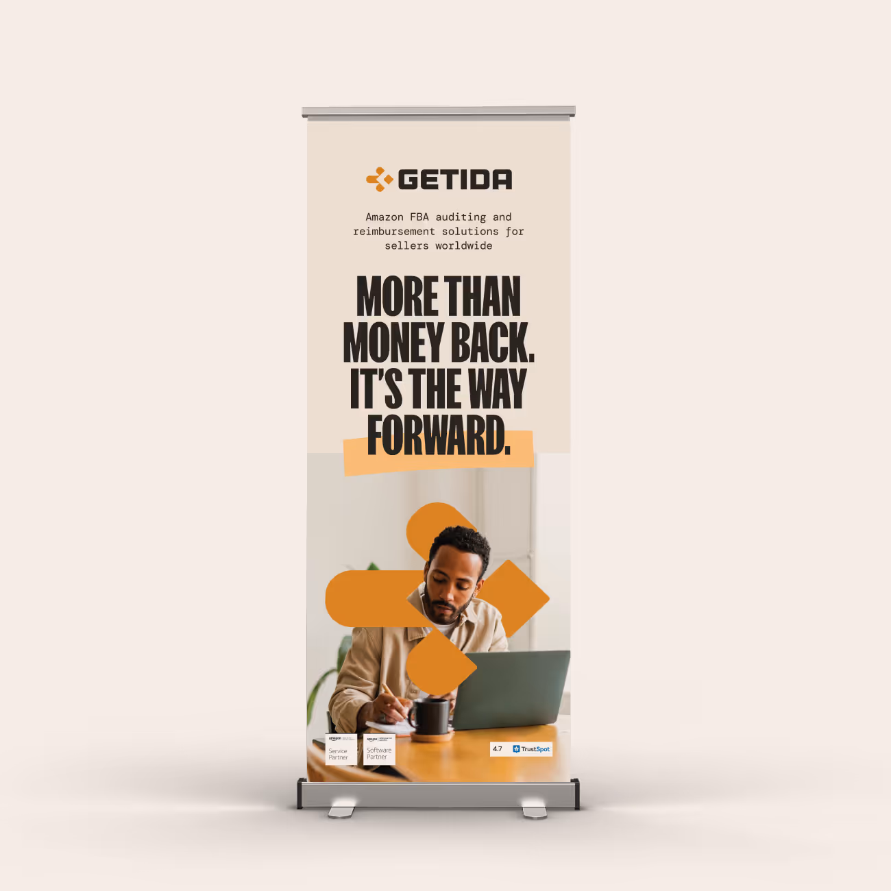 Banner with GETIDA logo and text about Amazon FBA auditing and reimbursement solutions, featuring a man writing beside a laptop.