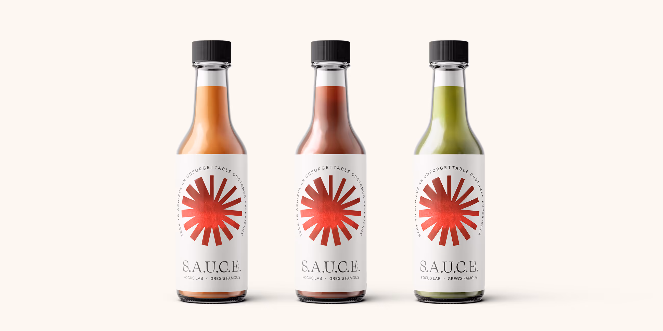 Three bottles of S.A.U.C.E. hot sauce in orange, red, and green varieties with black caps and white labels featuring a red sunburst design.