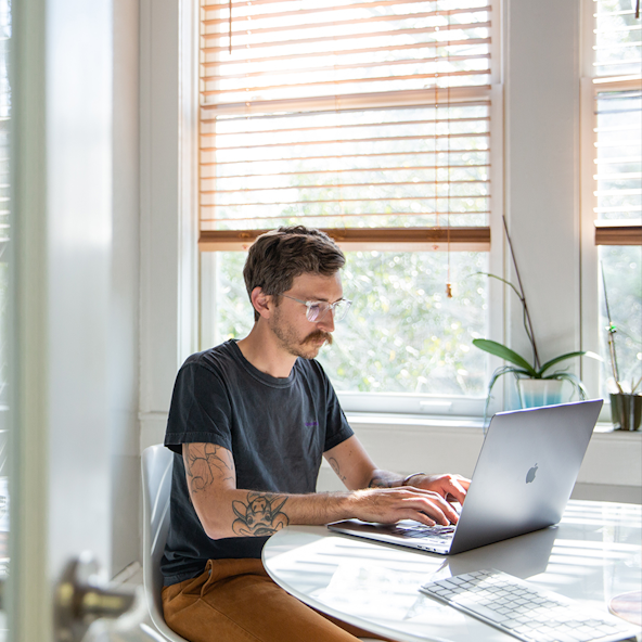 A designer works on a laptop