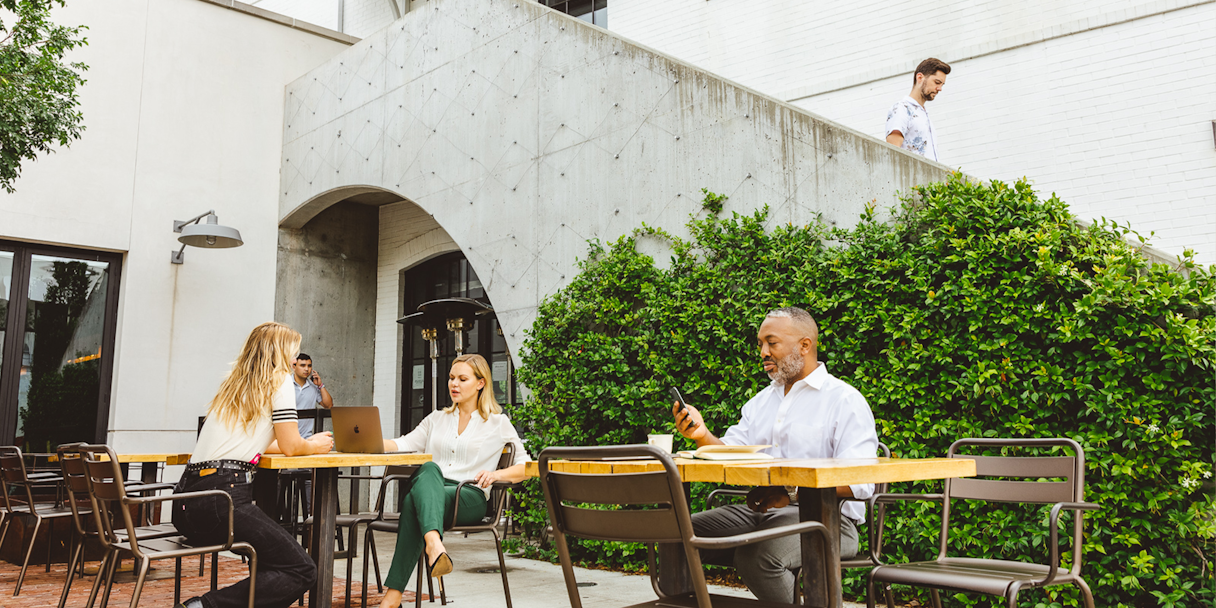 People sit in an outdoor courtyard